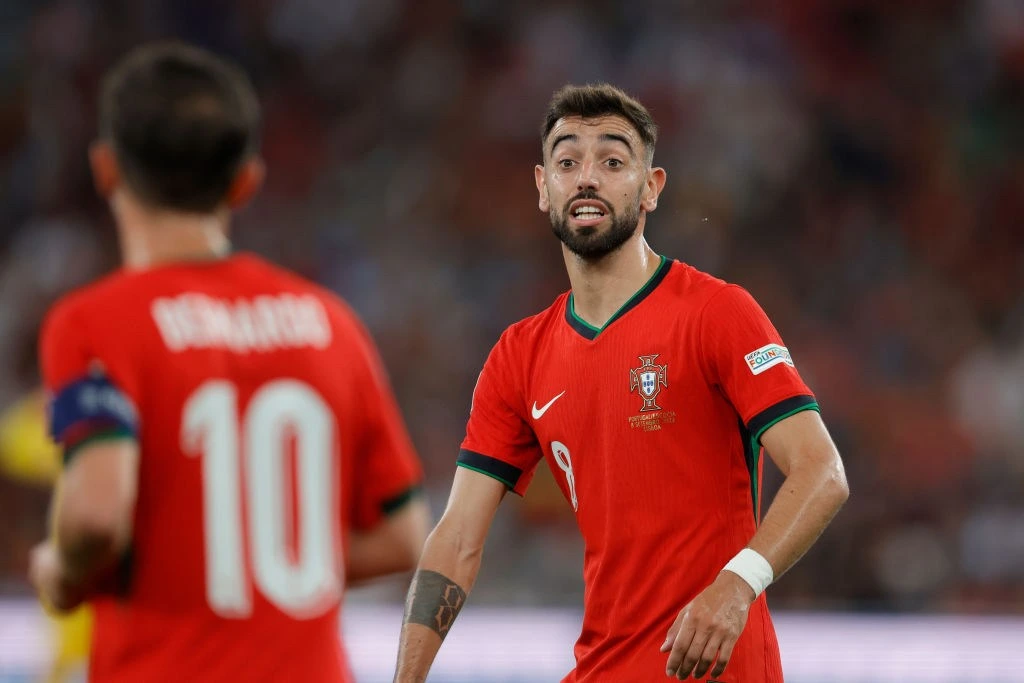 Bruno Fernandes celebrates with Cristiano Ronaldo after Portugal's dominant World Cup victory over Uzbekistan.