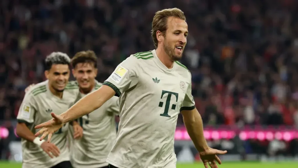 Harry Kane with the Ballon d'Or trophy in the background as Emmanuel Petit questions his Ballon d'Or chances after the 2026 World Cup.
