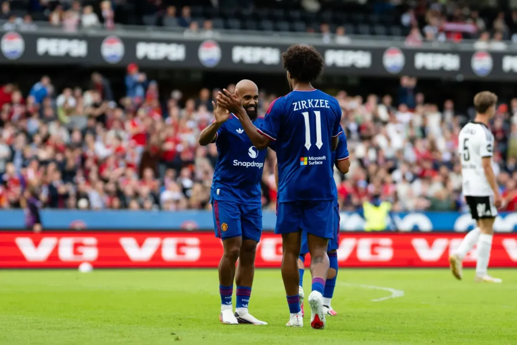 Manchester United players celebrate a dominant 5-0 victory over Rosenborg during a pre-season friendly match.