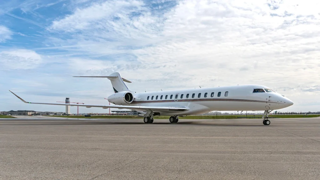 A Bombardier Global 8000 business jet flies above the clouds, showcasing its sleek design and high-performance aviation capabilities.