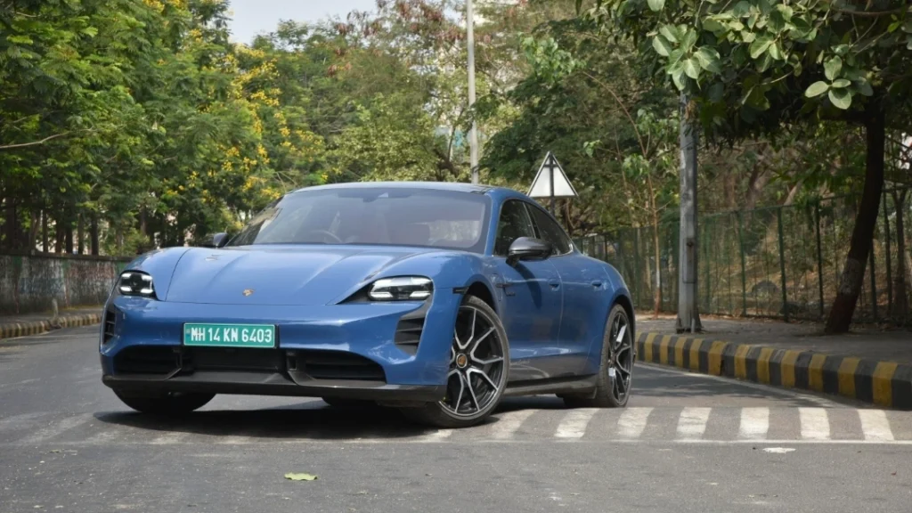Luxury EV Boom in India with premium electric cars parked outside a modern city skyline.