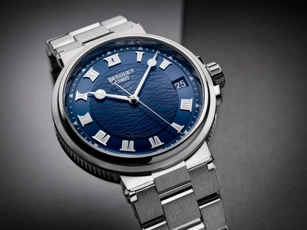 The updated Breguet Marine 5517 features the new Quai de l'Horloge guilloché dial, a centered 6 o'clock date window, and refined luxury styling for 2026.